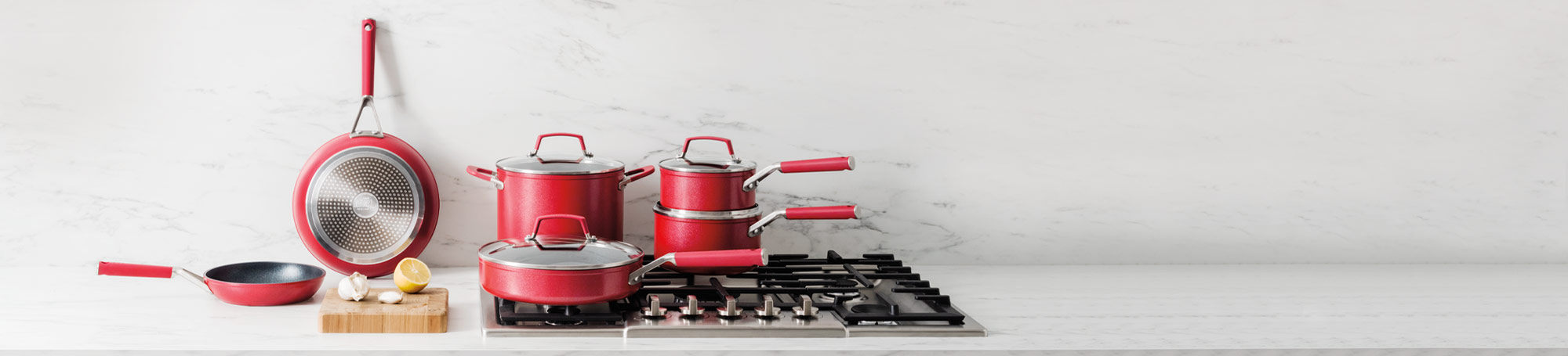 Red cookware on stovetop and countertop
