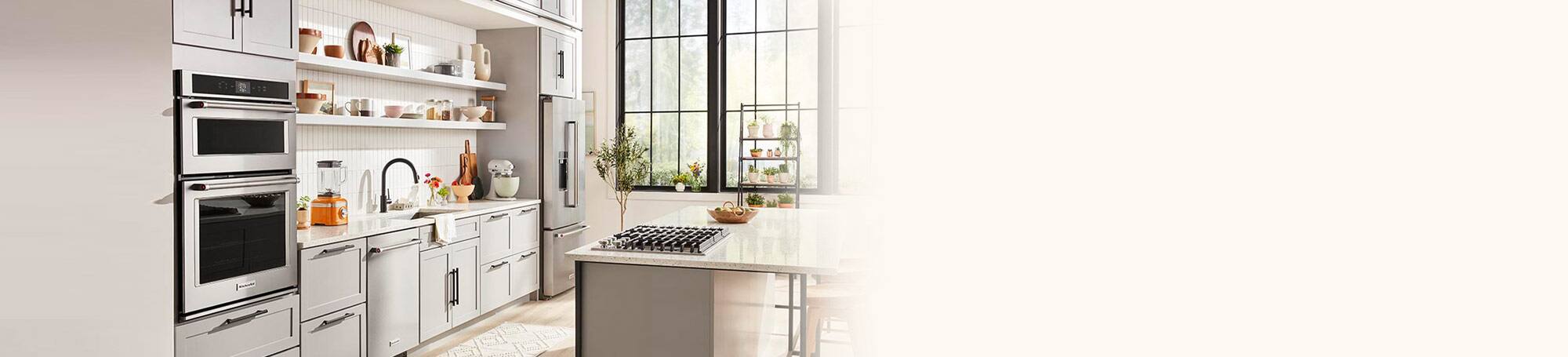 Bright kitchen with island and wall ovens