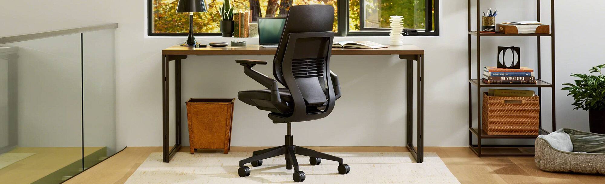 Back view of medium-colored in office area with black office chair 
