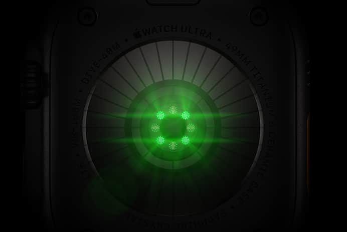 Back of Apple Watch Ultra 4, titanium case, black color, multiple round sensors with glowing green LED lights