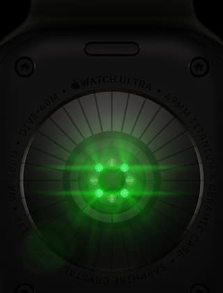 Back of Apple Watch Ultra 4, titanium case, black color, multiple round sensors with glowing green LED lights