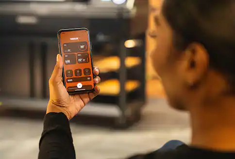 Person using grilling phone app