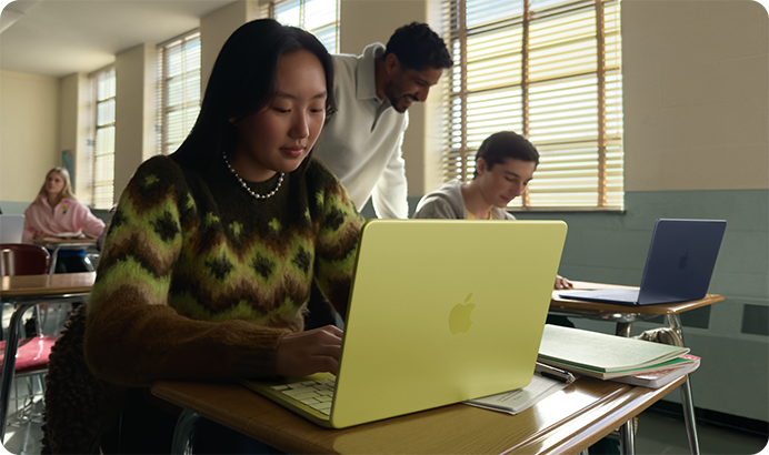 A student uses MacBook Neo, citrus color, unplugged in a classroom setting