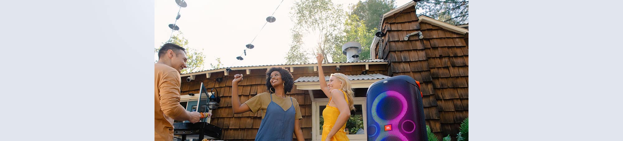 People dancing to music from outdoor speaker