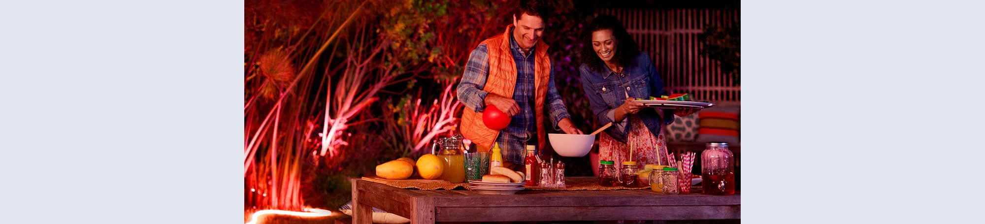 People surrounding outdoor dining set
