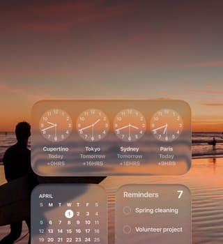 Liquid Glass Clock, Calendar, Reminders, and Weather widgets on macOS Tahoe screen over a scene of a surfer walking on the beach at sunset