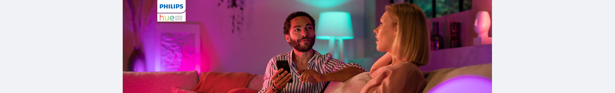 People in a room with shades of green and purple lighting, Philips, Hue personal wireless lighting