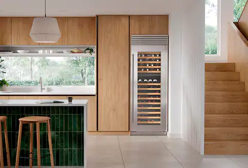 Wine cooler in green and brown kitchen