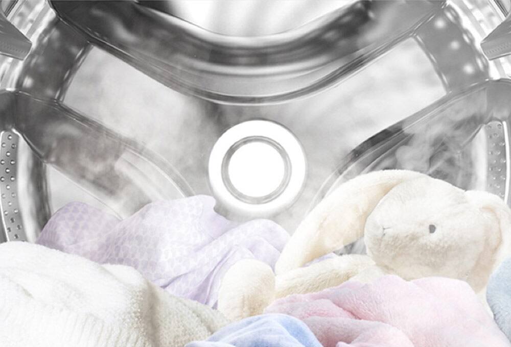 View inside washer with stuffed animal and steam