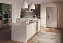 White kitchen with island, built-in appliances