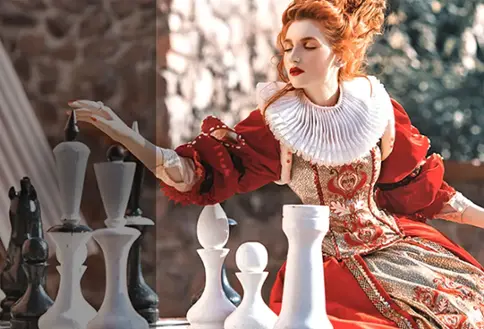 Movie theater and screen showing person and chess board. Part of the image is bright and part of it is shaded