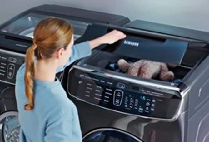 Woman opening washing machine