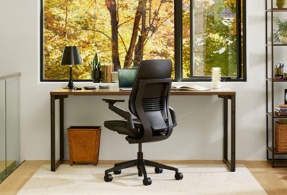 Black office chair and brown desk in office