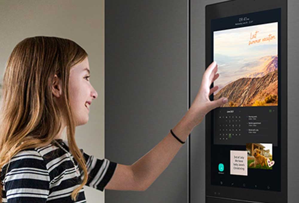 Person interacting with touch screen on refrigerator