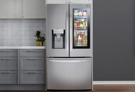 Stainless steel refrigerator with glass window panel in gray kitchen