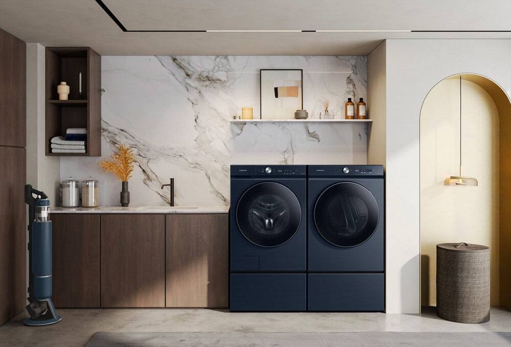 Navy washer and dryer in white laundry room