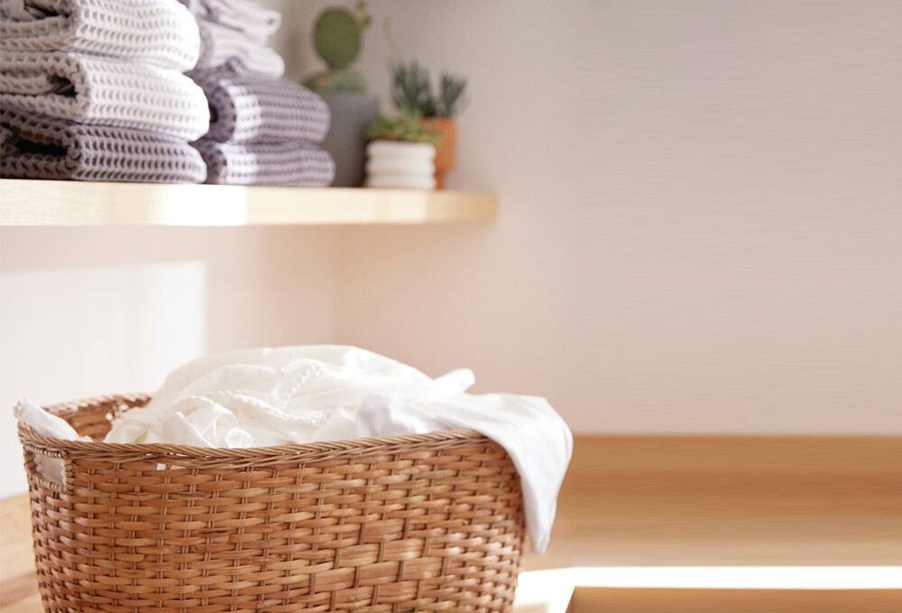 Basket of white laundry in laundry room