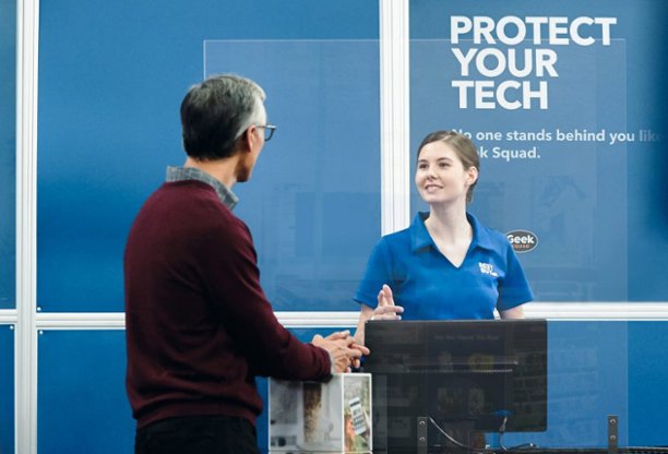 Blue shirt employee with customer