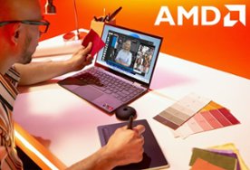 Person at desk with laptop and graphics tablet, AMD