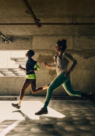 A group of people running in a city while wearing Apple Watch Series 12