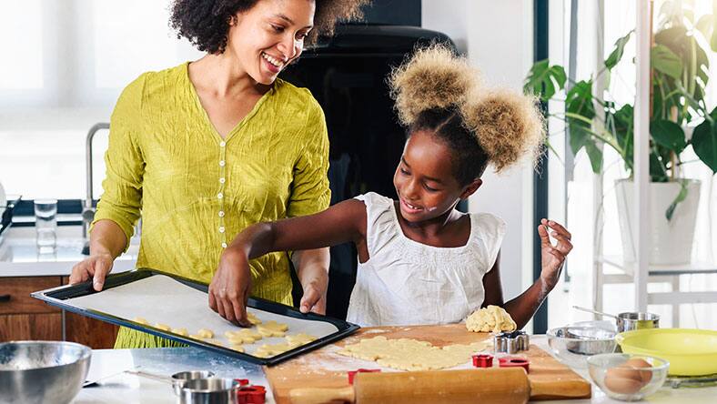 Mother teaching child to cook