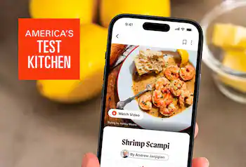 Culinary dish displayed on a phone, America’s Test Kitchen logo