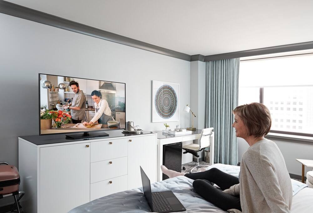 Person watching TV in a hotel room