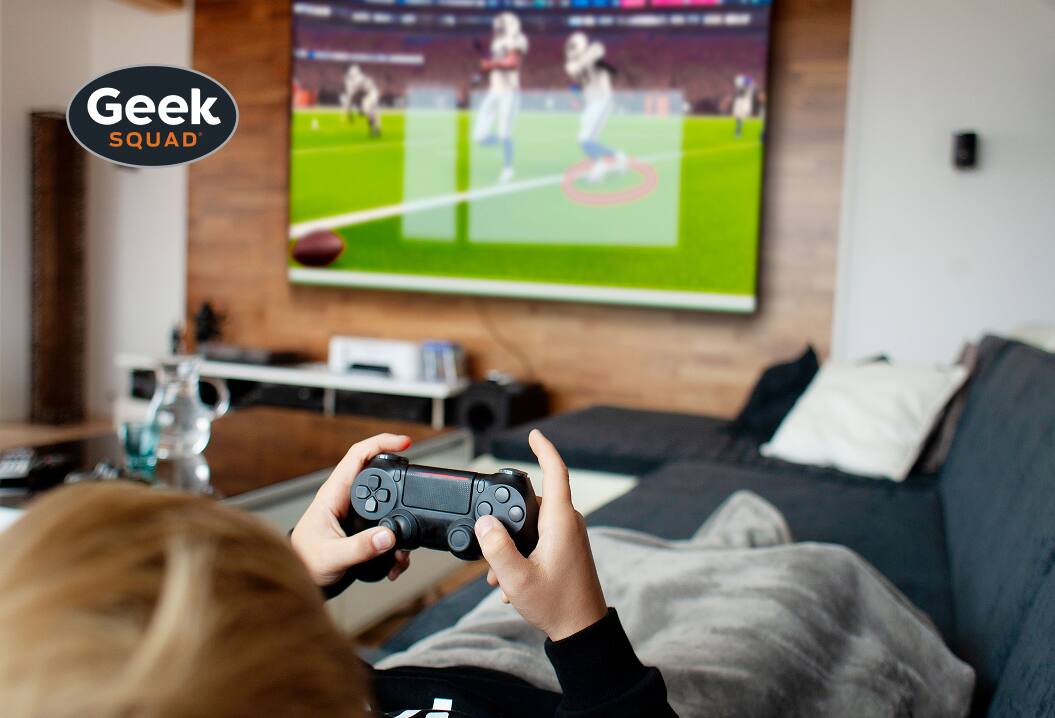 Geek Squad® - Person playing video game on console