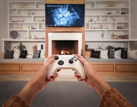 Person holding video game controller in living room
