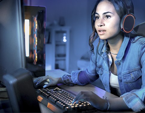 Woman playing video games at computer