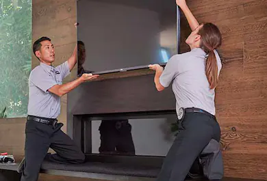 Geek Squad Agents installing digital sign