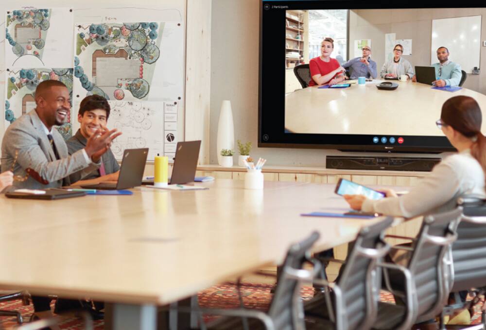 Woman presenting graph to two men
