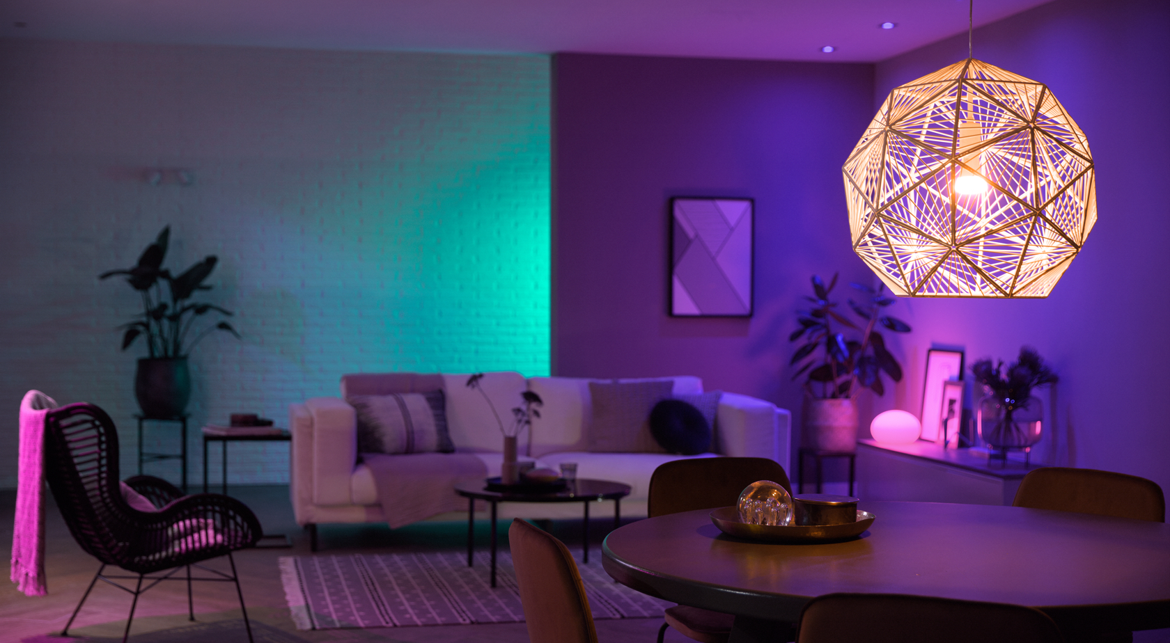 Living space with shades of green, pink and purple lighting