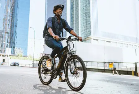 Man riding electric bicycle in city