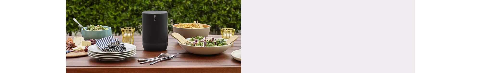 Portable speaker on dining table outside