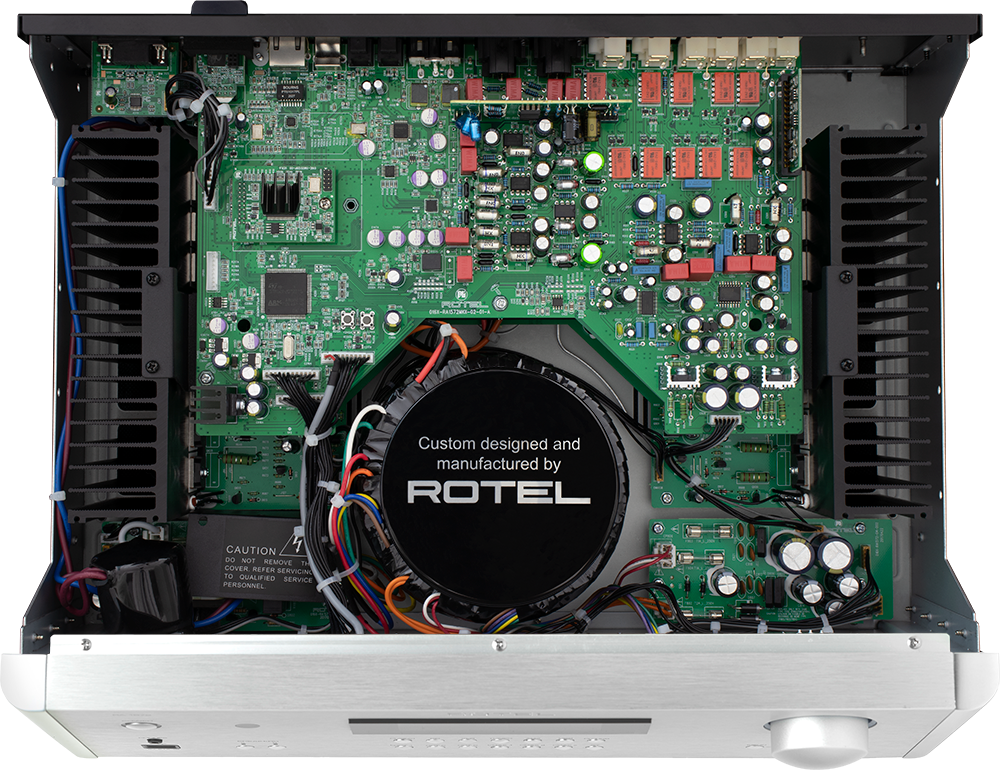 The text on the image is: "Custom designed and manufactured by ROTEL. Caution: Do not remove the cover. Refer servicing to qualified service personnel."