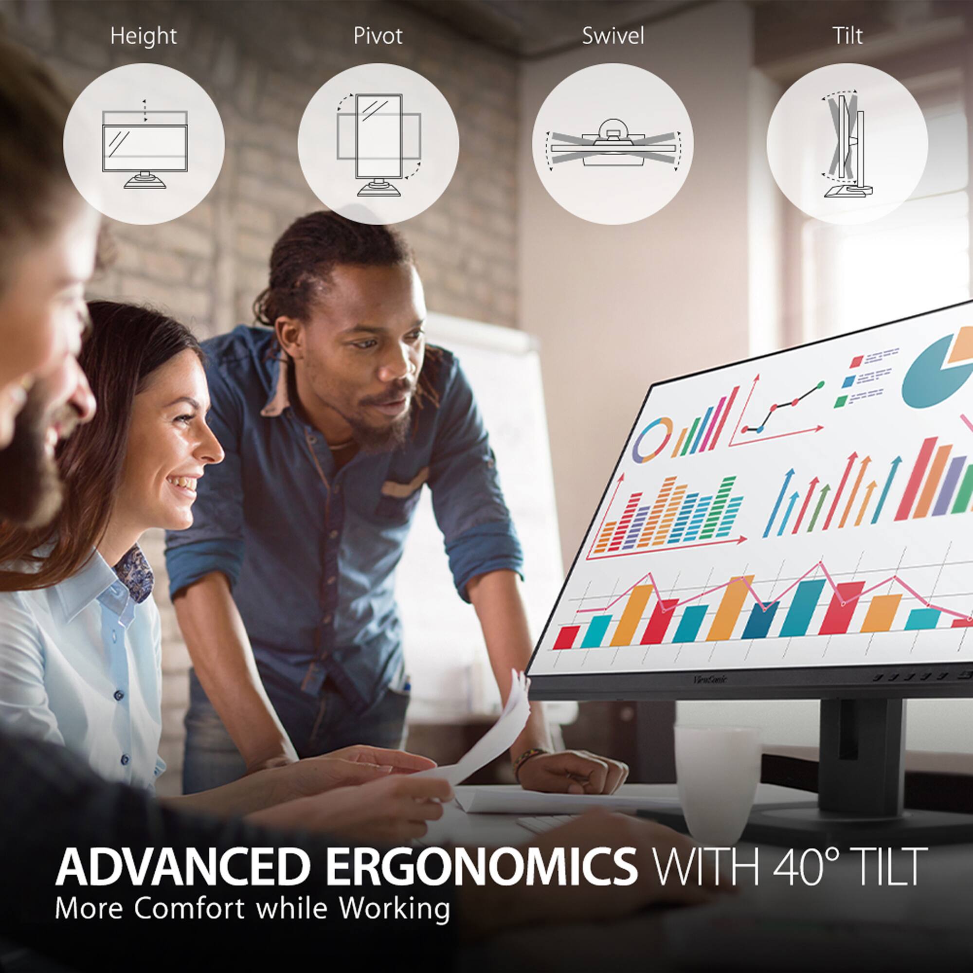 The image features a man and a woman sitting in front of a large computer monitor. The woman is sitting on the left side of the monitor, while the man is sitting on the right side. They are both smiling, indicating that they are enjoying their time together. The computer monitor is placed on a desk, and there are two cups nearby, one on the left side and another on the right side of the monitor. The scene suggests a comfortable and pleasant working environment.