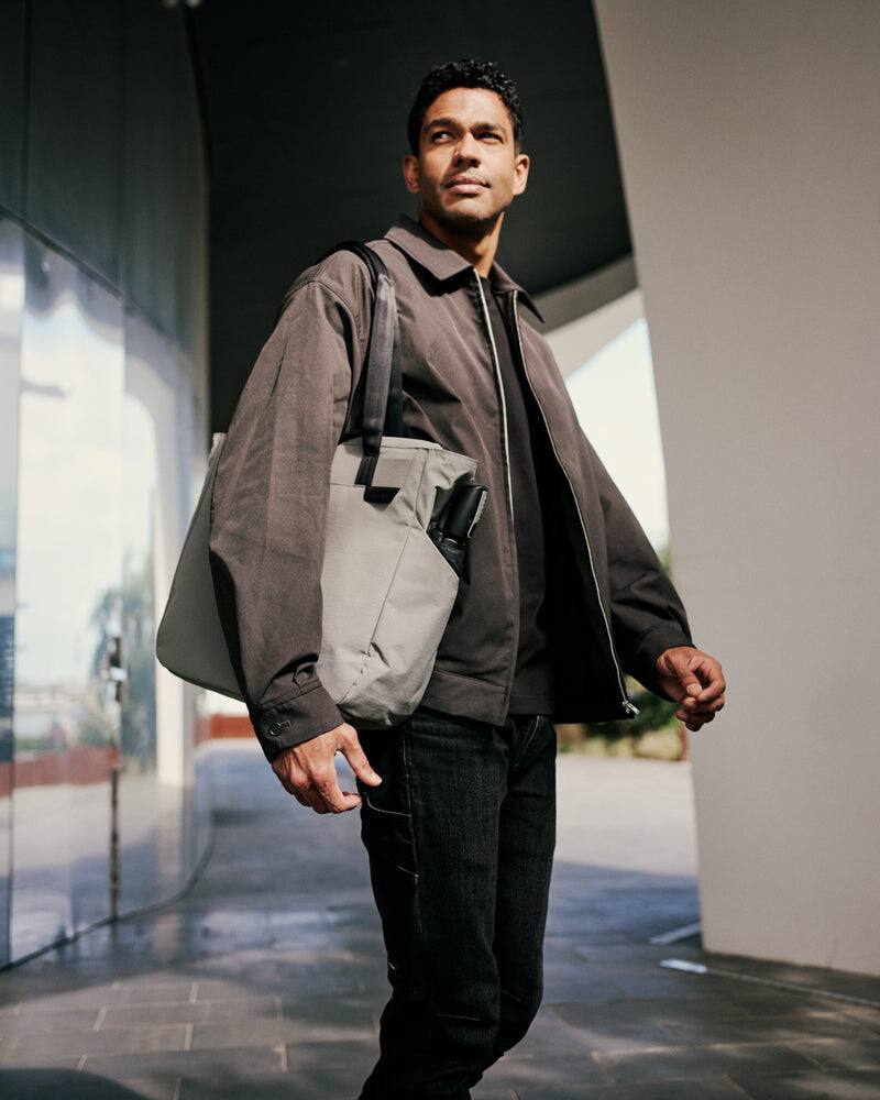 Alt View 2. ALPAKA - Metro Tote Laptop Tote Bag for Work, Work Tote Fits 16" MacBook Pro, Side Bottle Pocket, Weather-Resistant, Key Tether - Grey Axoflux 210D.