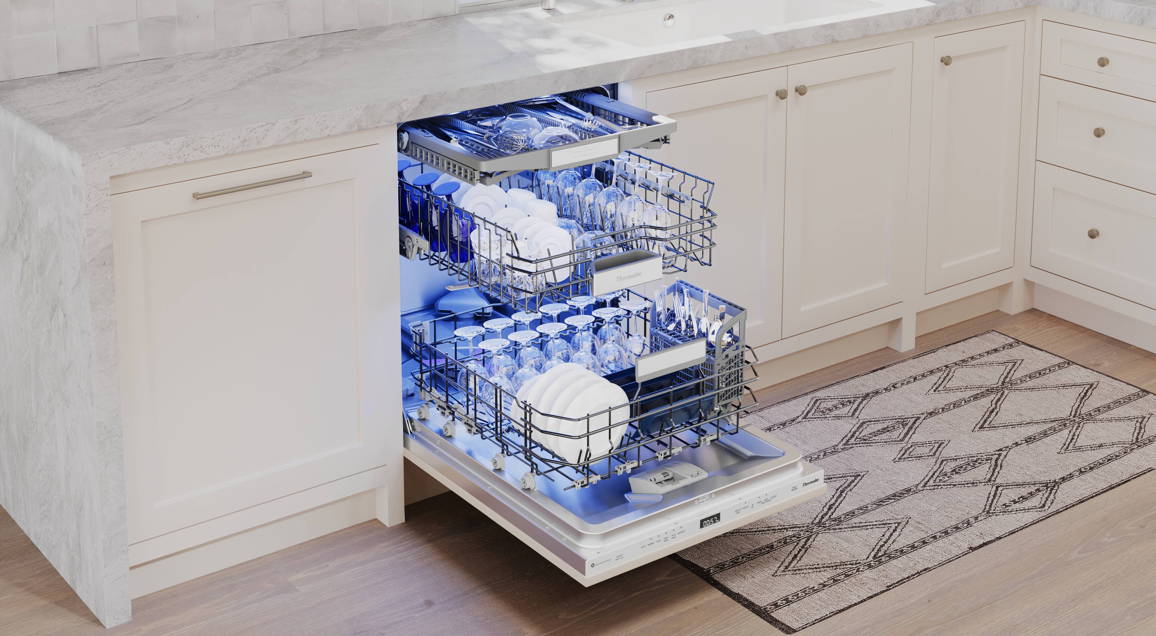 The image shows a kitchen with a dishwasher built into the cabinetry. The dishwasher is filled with dishes, and it appears to be a modern, built-in model. The kitchen also features a sink and a rug on the floor.