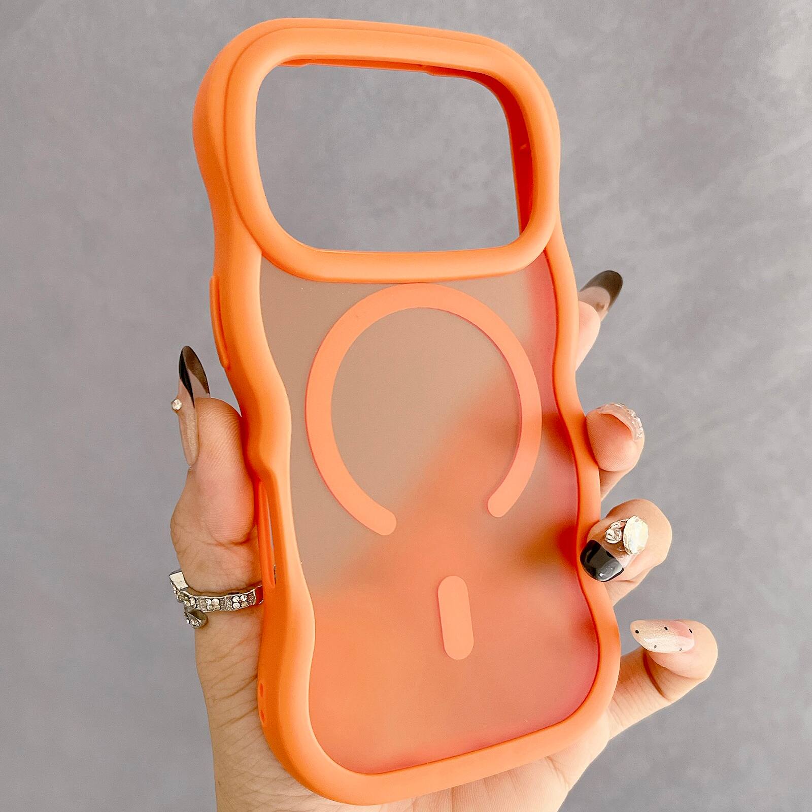 Angle. Dteck - Curly Wavy Frame Case for iPhone 17 Pro Max, Compatible with MagSafe, Shockproof Translucent Frosted Back Phone Cover - Orange.