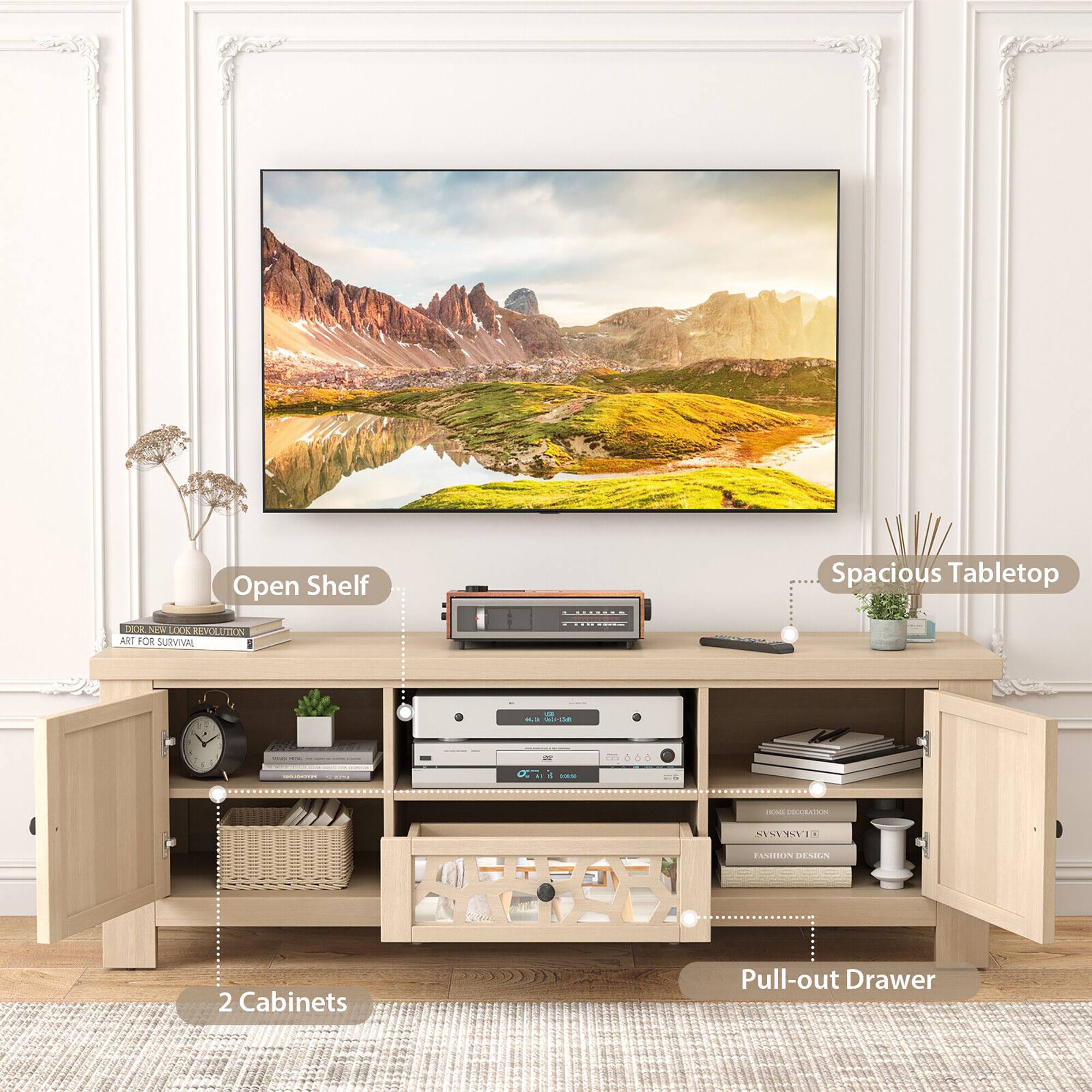 The image features a desk with a large flat screen TV mounted on the wall above it. The desk has a pull-out drawer and two cabinets, providing ample storage space. Additionally, there is a clock on the desk, and a potted plant is placed nearby. The desk also has a speaker system, enhancing the overall entertainment experience.