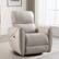 The image shows a white leather chair with a matching ottoman. The chair is positioned in front of a window, and there is a rug beneath it. The chair is comfortable and inviting, making it an ideal spot for relaxation or reading.