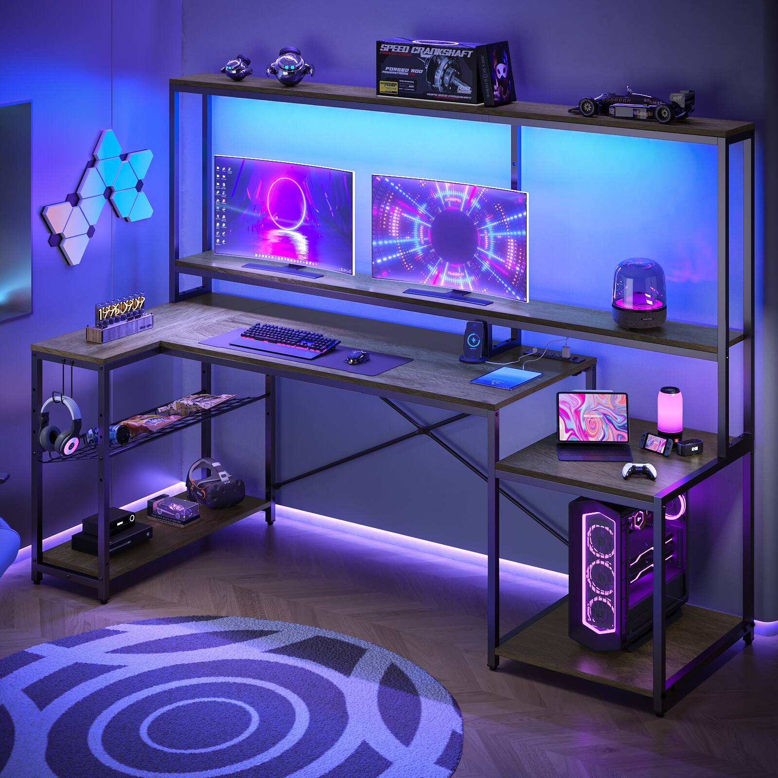 The image shows a computer desk with a keyboard and mouse on it. The desk is surrounded by shelves with various items on them, including a laptop, a cell phone, and a TV. There are also multiple books and a cup placed on the desk. The desk is positioned in a room with a purple carpet, and the room appears to be dimly lit.