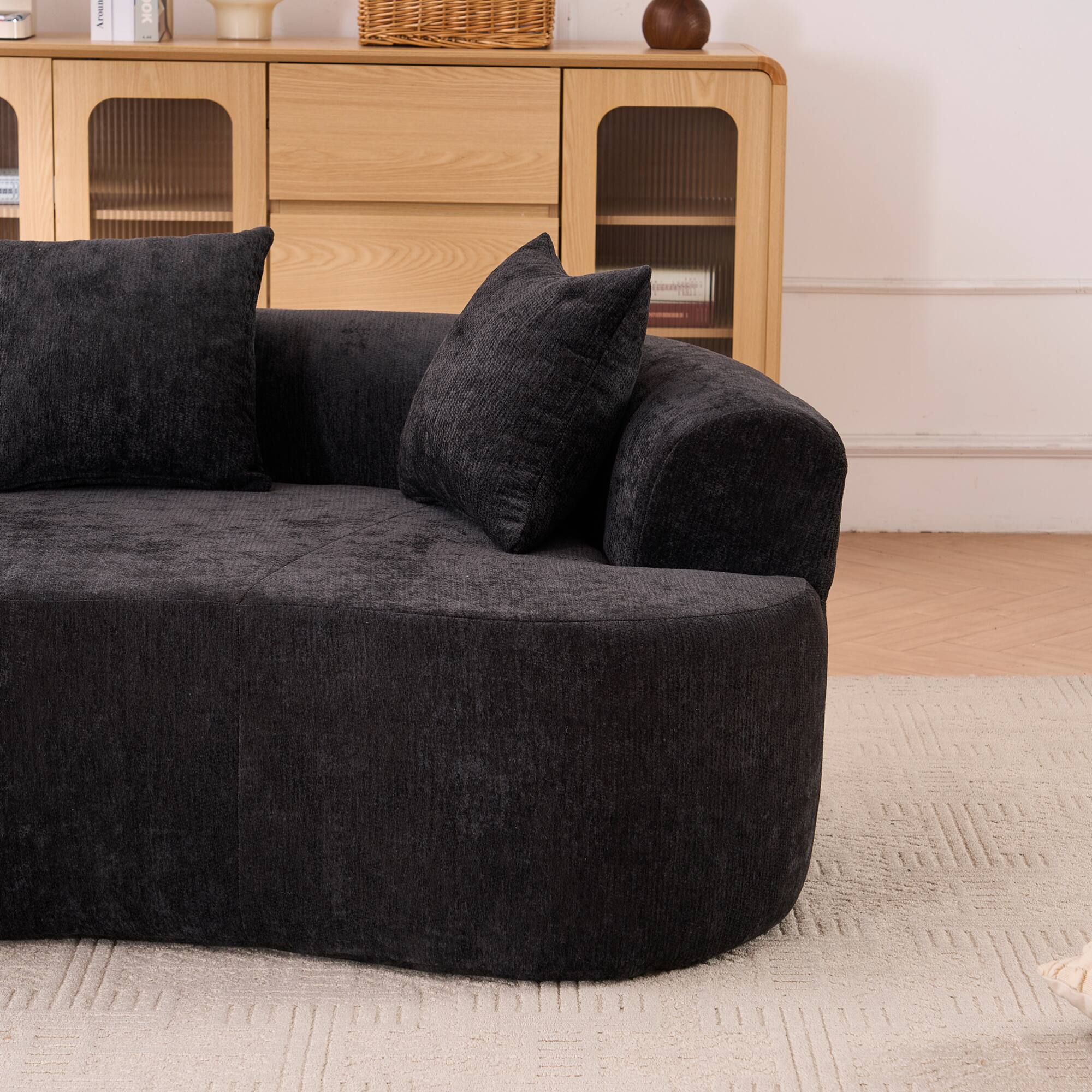 Angle. GOODSILO - Modern Crescent-Shaped Sofa with Deep Cushions and Self-Inflating Foam, Three-Seater Design for Ultimate Comfort - Black.