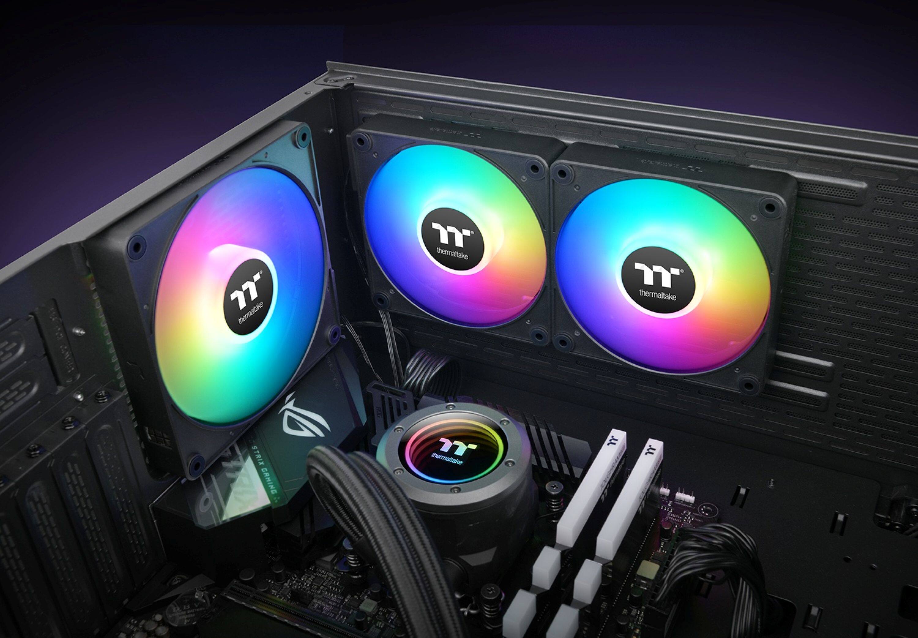 The image features a computer with a Thermaltake logo on its side. The computer is equipped with four fans, two of which are colorful and rainbow-colored, while the other two are black and white. The fans are positioned in front of the computer, with two of them on the left side and two on the right side. The computer is likely designed to handle high temperatures and provide efficient cooling for its components.