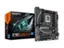 The image features a Gigabyte motherboard and a box of the same brand. The motherboard is displayed prominently, with the box placed next to it. The box is open, revealing the motherboard inside. The combination of the motherboard and the box suggests that the product is new and ready for use.