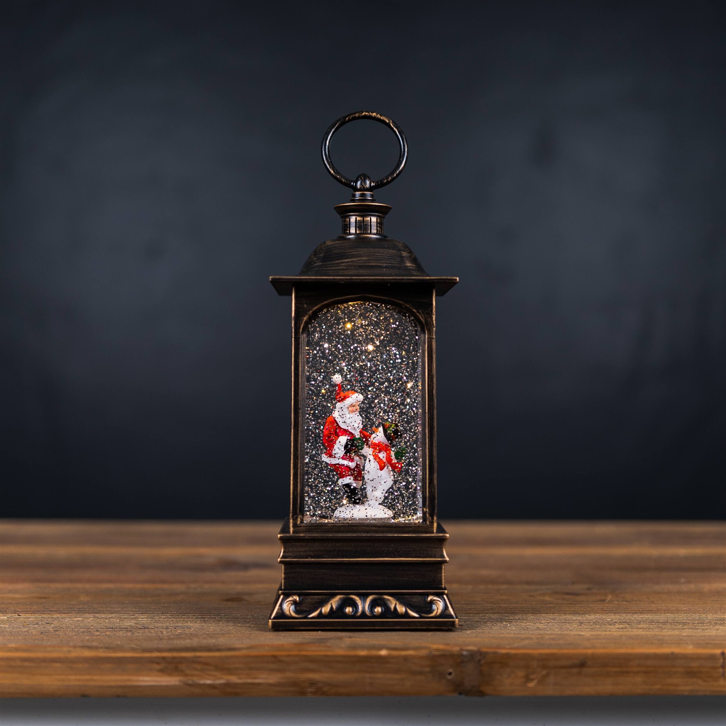 Angle. BreeBe - LED Snow Globe Lantern with Santa and Snowman 10.5"H - Bronze, Red.