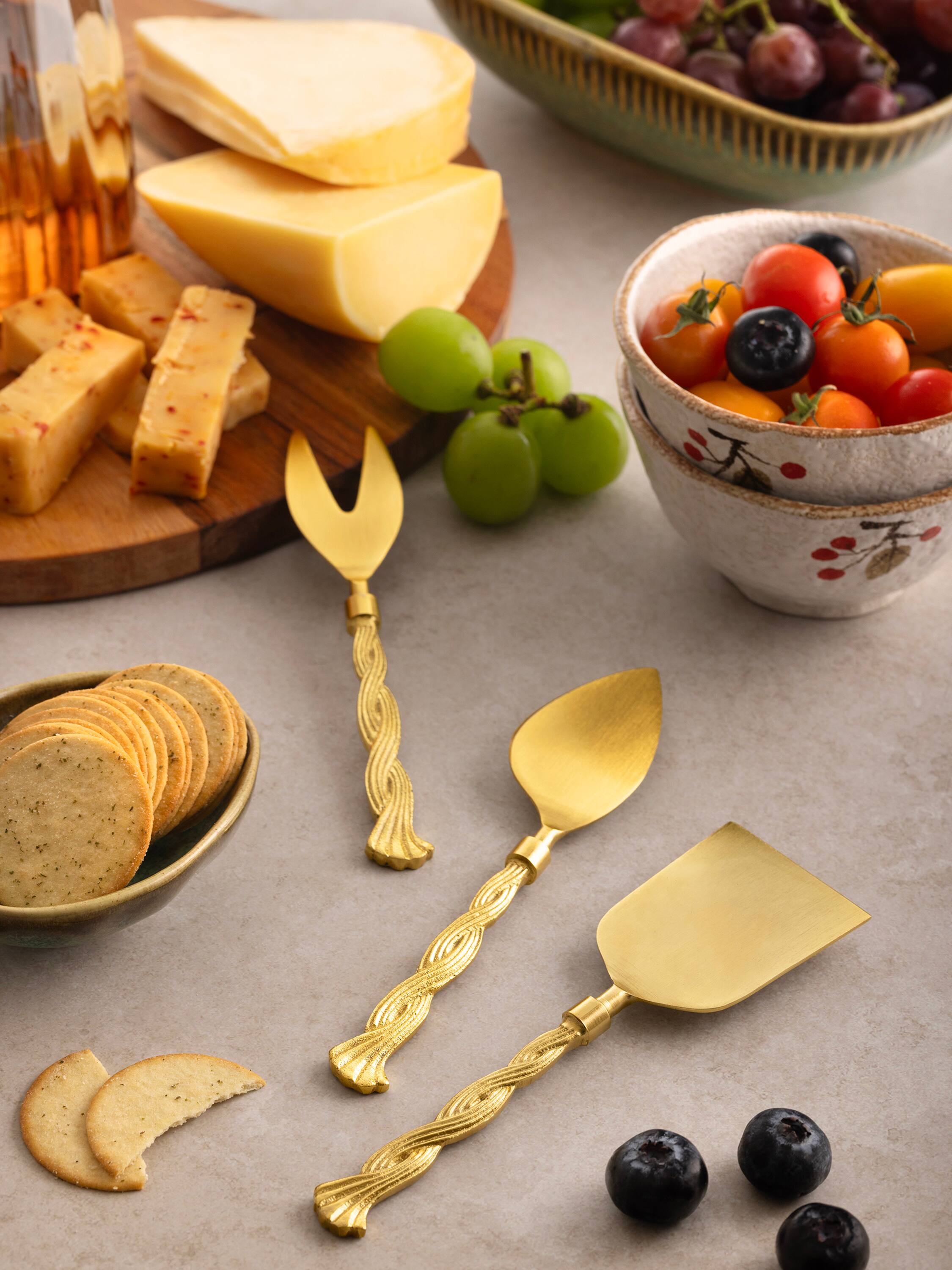 Left. GAURI KOHLI - Santiago Cheese Knives - Matte gold.
