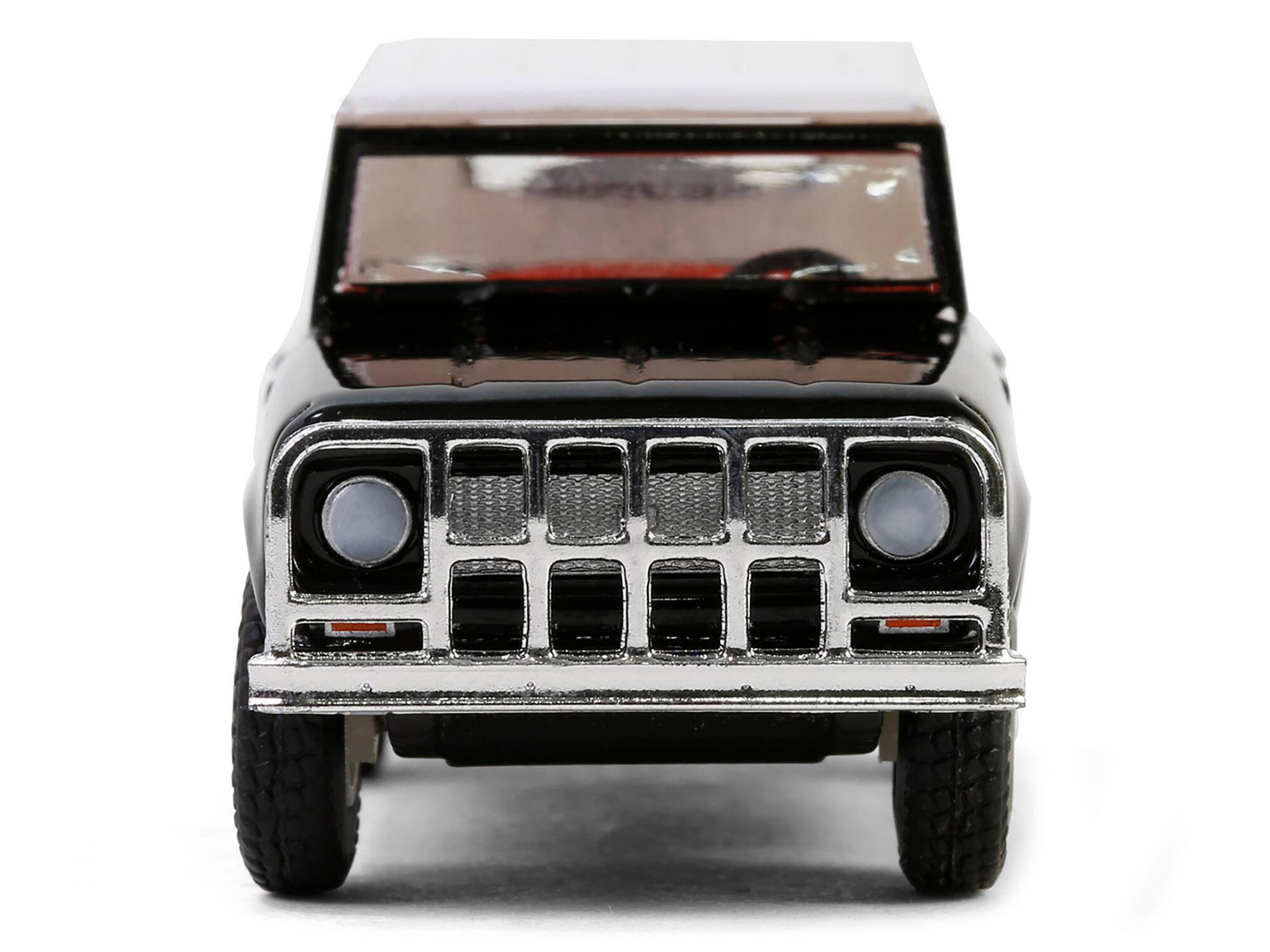 Left. Greenlight - 1963 Harvester Scout "Texaco" Black with White Top and Red Interior "Texaco Special Edition" Series 1 1/64 - Black with White Top and Red Interior.