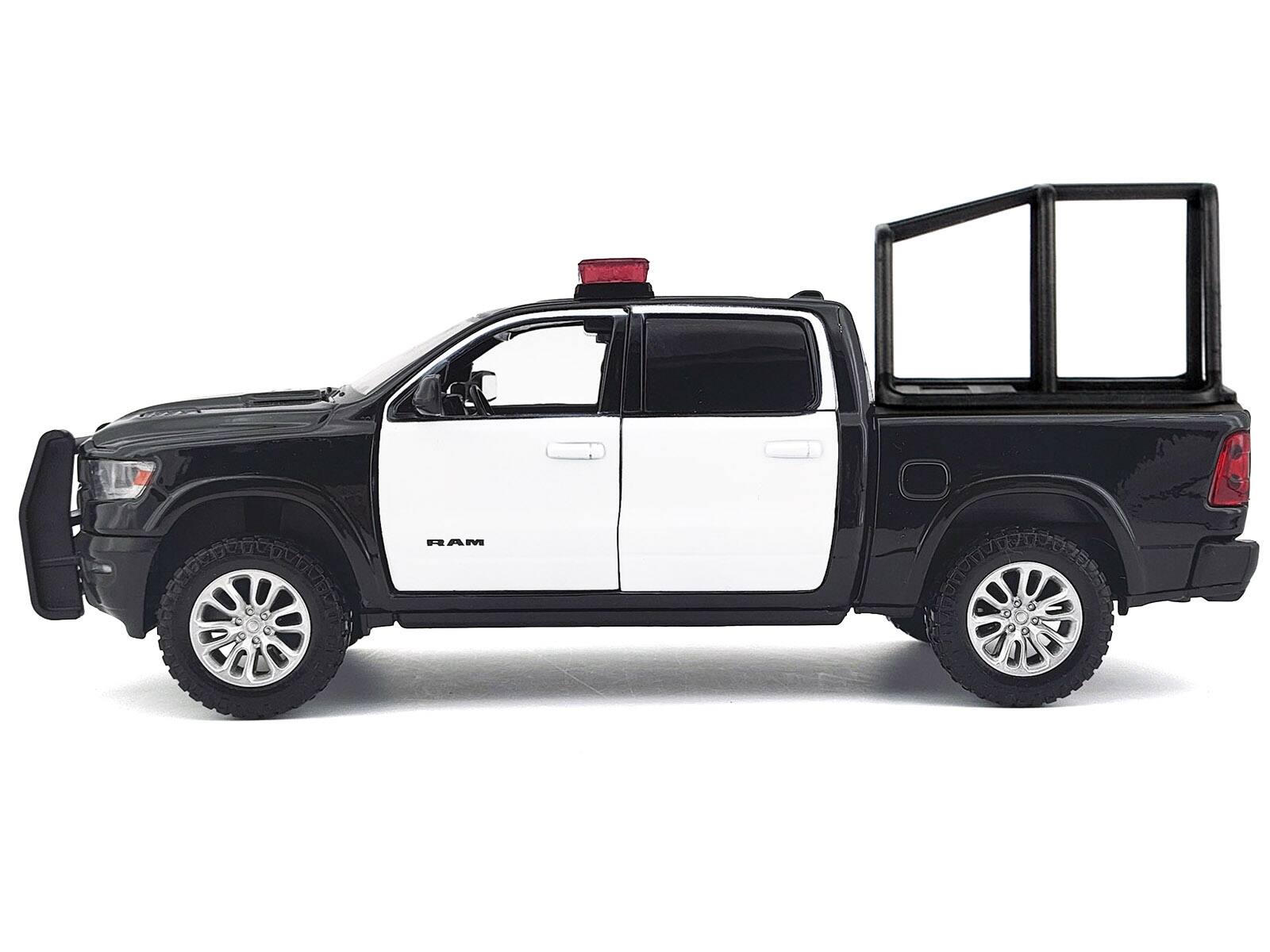 Alt View 2. Motormax - 2019 RAM 1500 Laramie Crew Cab Truck with Bed Cage Black and White with Lights and Sounds 1/27 Model Car by Motormax.